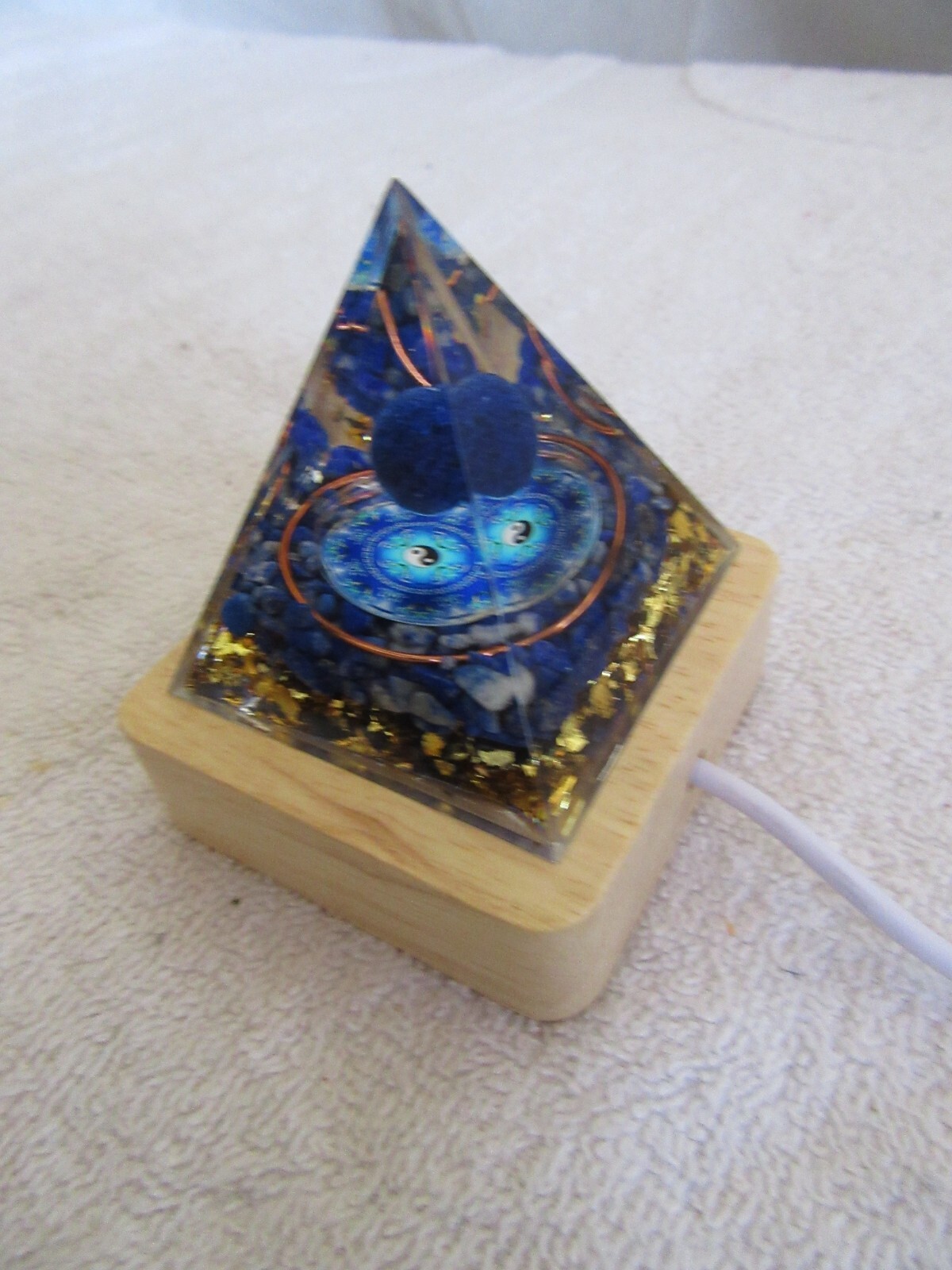 Orgone Pyramid (2) 1 Blue yin/yang symbol 1 random mystery w/lighted wood base.