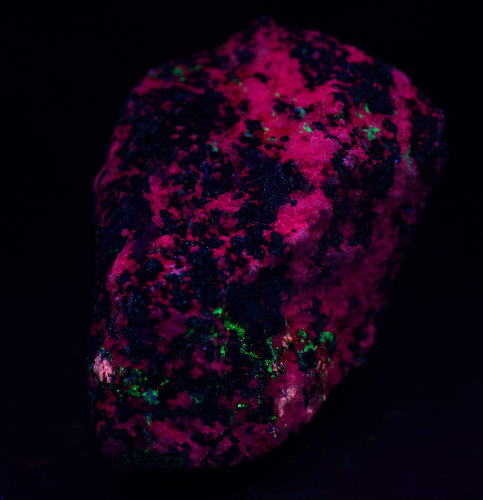 Eudialyte specimen with multiple other minerals UV. Kipawa, Canada. 323 grams.