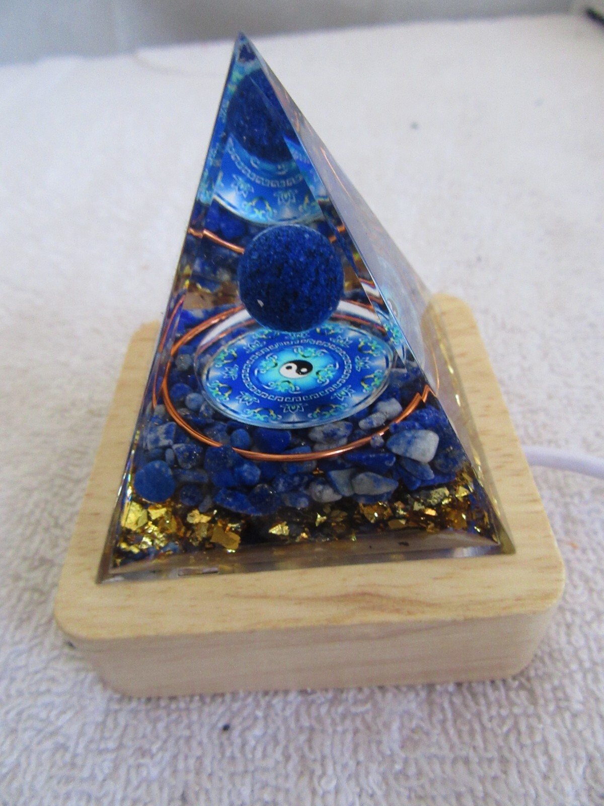Orgone Pyramid (2) 1 Blue yin/yang symbol 1 random mystery w/lighted wood base.