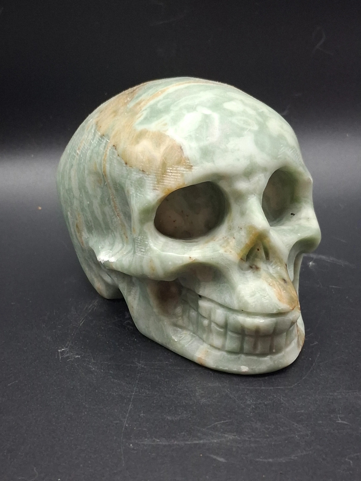 Green calcite skull! 1.4 pounds, 3.5 inches long, 2.7 inches tall