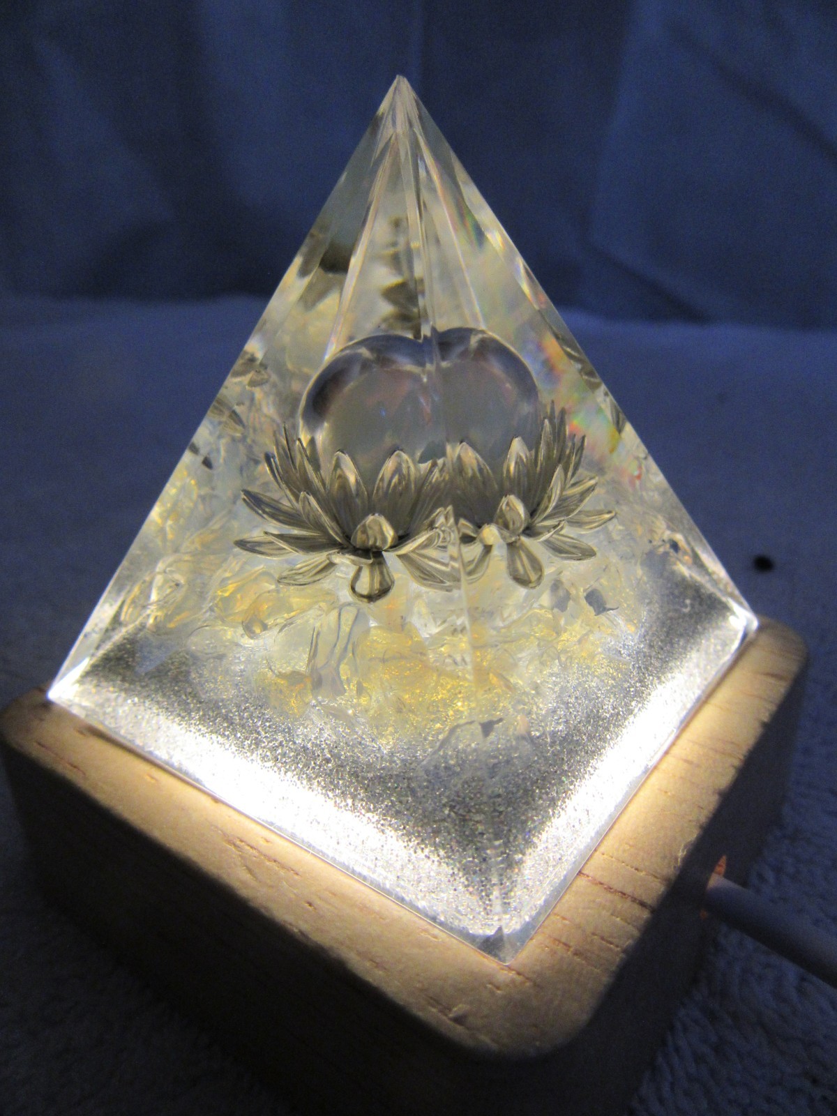 Orgone Pyramid silver-gold Pyramid with white lighted wood base