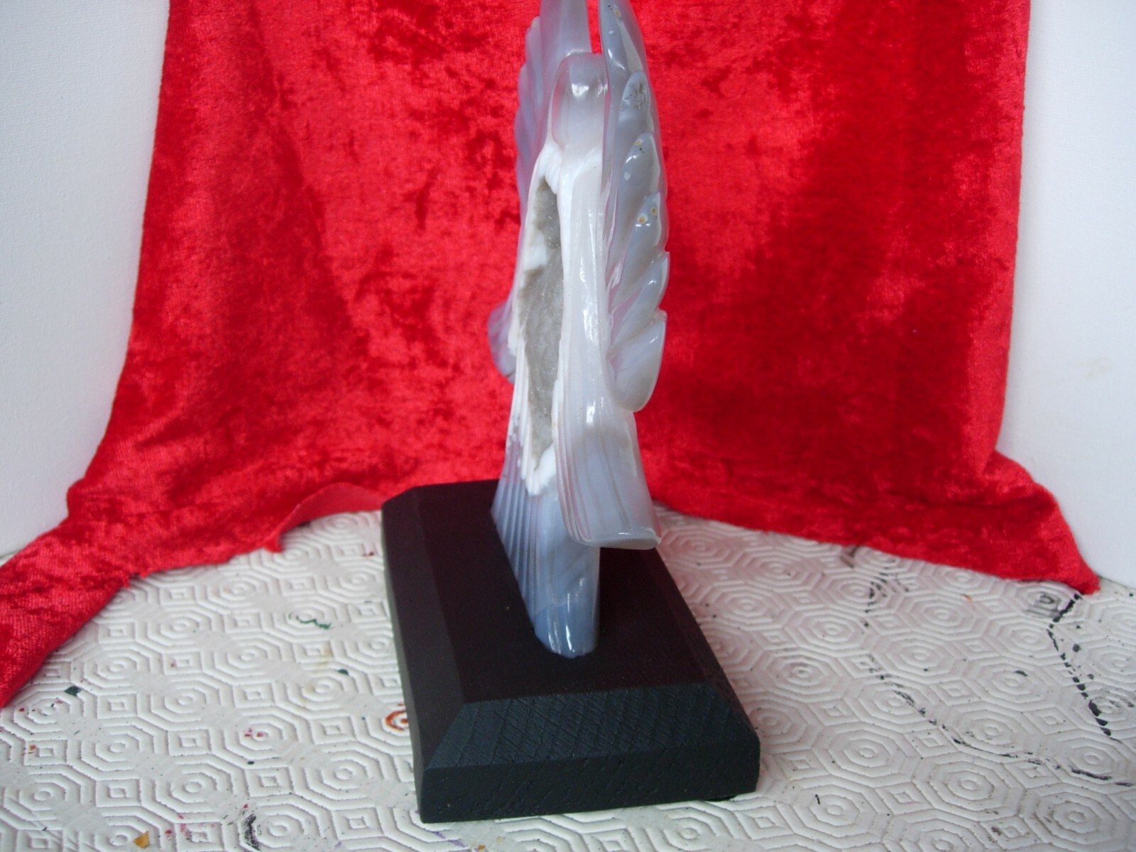 agate angel carving with geode formation on hardwood base